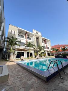 a swimming pool in front of some buildings at Yoyo Kunda in Banjul