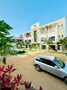 a car parked in a parking lot in front of a building at Yoyo Kunda in Banjul