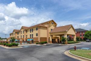 a large hotel with a parking lot and a fire hydrant at Comfort Inn Garner Clayton I-40 in Edmondson