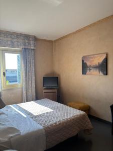 a hotel room with a bed and a window at Hotel Giglio in Montecatini Terme +56 photos
