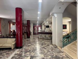 a lobby with red columns in a building at Hotel Giglio in Montecatini Terme