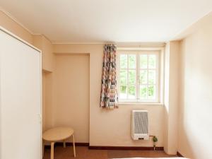 a room with a window and a table and a chair at Gorgeous Apartment in Bohon with Garden Furniture and BBQ in Barvaux