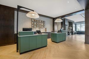 an office lobby with green counters and desks at Cambria Hotel Bend - Mt Bachelor in Bend