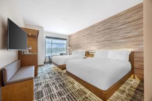 a hotel room with two beds and a flat screen tv at Cambria Hotel Bend - Mt Bachelor in Bend +112 photos