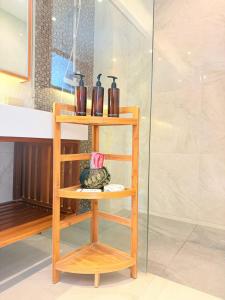 a wooden shelf with bottles on it in a bathroom at Saengsuree Villas Koh Yao Yai in Ko Yao Yai
