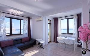 a living room with a couch and a table at Deluxe Nicolle Solid Residence Mamaia in Mamaia +112 photos
