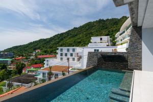 a view of a building with a swimming pool at Villa Omari Seaview Pool & Game Room Kata in Kata Beach
