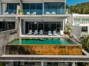 an aerial view of a house with a swimming pool at Villa Omari Seaview Pool & Game Room Kata in Kata Beach