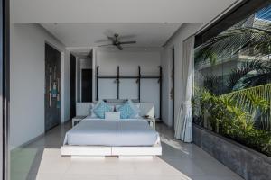 a bedroom with a bed with blue pillows at Villa Omari Seaview Pool & Game Room Kata in Kata Beach +73 photos