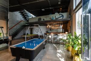 a pool table in a room with a staircase at Villa Omari Seaview Pool & Game Room Kata in Kata Beach