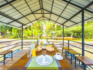 a table with plates of food on top at Splendid Lake View Safari Lodge in Udawalawe