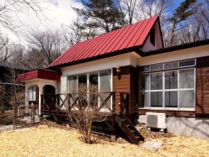 a small house with a red roof at rinne 那須 Garden 3 in Nasu