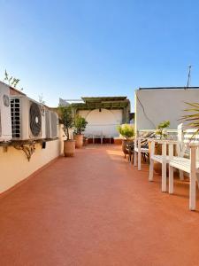 a patio with tables and chairs and an air conditioner at Dar la famille Marrakech in Marrakesh