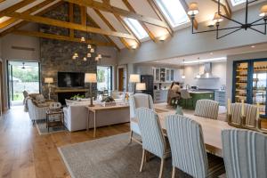 a dining room and living room with a table and chairs at Brookdale Estate - Manor House in Paarl