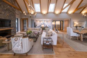 a living room with white furniture and a fireplace at Brookdale Estate - Manor House in Paarl