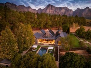 an aerial view of a house with a pool and mountains at Brookdale Estate - Manor House in Paarl