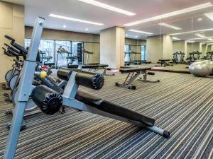a gym with several treadmills and machines at Mercure Chongqing Downtown in Chongqing