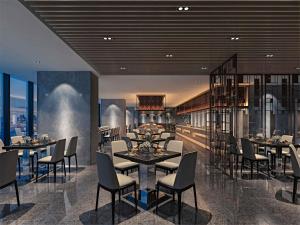 a restaurant with tables and chairs in a room at Mercure Chongqing Downtown in Chongqing