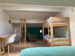 a bedroom with two bunk beds and a table and a desk at Home in Drome provençale in Vesc