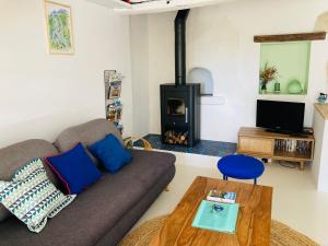 a living room with a couch and a fireplace at Home in Drome provençale in Vesc