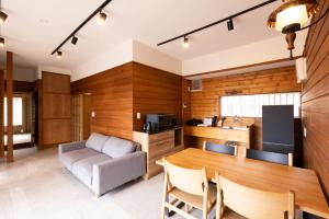 a kitchen and living room with a table and a couch at rinne 那須 Garden 3 in Nasu