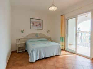 a bedroom with a bed and a large window at Le Residence del Golfo Orosei in Orosei +43 photos