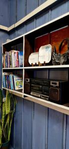 a shelf with a radio and other items on it at Nhiên Café & Homestay in Xuân Trường