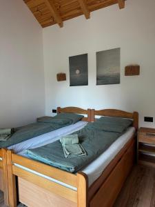 a bedroom with a wooden bed with green sheets at Montana Goc in Goč