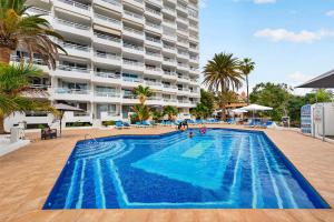 a large swimming pool in front of a large building at Bella vista in Playa Fañabe