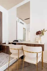 a kitchen with a table and two chairs at La Maison Parliament by BQA in Budapest