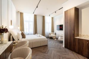 a bedroom with a bed and a living room at La Maison Parliament by BQA in Budapest