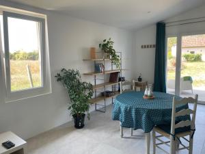 a dining room with a table and a potted plant at Préchacq-les-Bains in Préchacq +3 photos