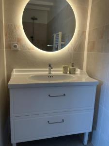 a bathroom with a white sink and a mirror at Préchacq-les-Bains in Préchacq