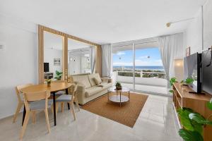 a living room with a table and a couch at Bella vista in Playa Fañabe