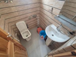 an overhead view of a bathroom with a toilet and a sink at Gyatso Home Saty in Kaza