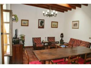 a living room with a wooden table and chairs at Casa Rural los Ajaches in Yaiza