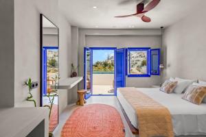 a bedroom with blue doors and a bed and a window at Alexandros Apartments in Naousa +288 photos