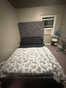 a bedroom with a large bed with a floral bedspread at Alvin Relax in El Cajon