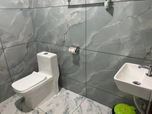 a bathroom with a toilet and a sink at Bright Nest Service Villa Munroe in Kollam +26 photos