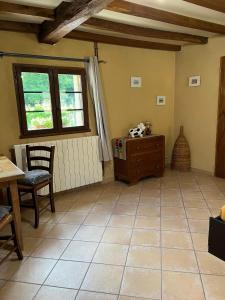 a living room with a table and a window at Chez Fayolle in Montagnac-la-Crempse +7 photos