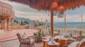 a patio with furniture and a view of the ocean at Stratus Resort in Khao Kho