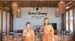 two women doing yoga in front of a restaurant at Stratus Resort in Khao Kho