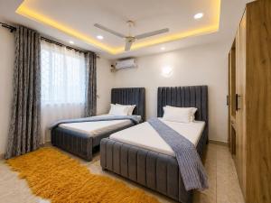 a bedroom with two beds and a window at Nyali 3 Bedroom Apartment Skyview in Mombasa