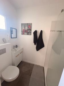 a bathroom with a toilet and a sink at Patio in Gamarde-les-Bains