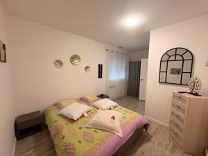 a bedroom with a bed and a dresser at Patio in Gamarde-les-Bains