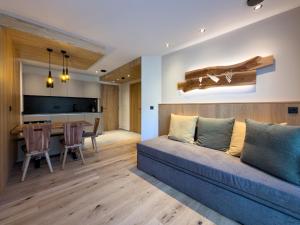 a living room with a couch and a table at Weingut Santer Apartments in Mühlbach