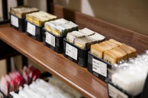 a row of different types of food on a shelf at KOKO HOTEL Osaka Shinsaibashi in Osaka