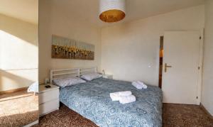 a bedroom with a bed with two towels on it at Apartment Di Lago by GardaDoma in Brenzone sul Garda