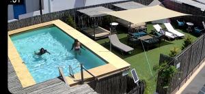 two people are swimming in a swimming pool at Aliki Panorama Rooms -breakfast included- in Aliki