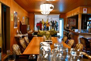 a dining room with a wooden table and chairs at Echoland Madarao エコーランド斑尾 All en-suite rooms & a free 3-minute shuttle to the ski resort in Madarao Kogen